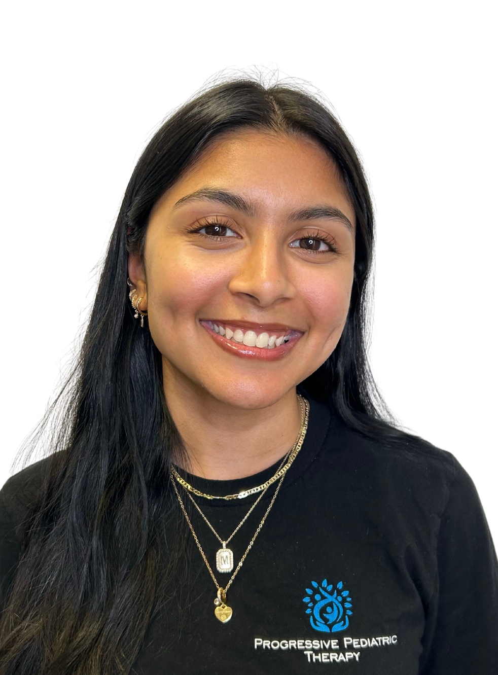 A woman wearing a black shirt and a necklace is smiling.