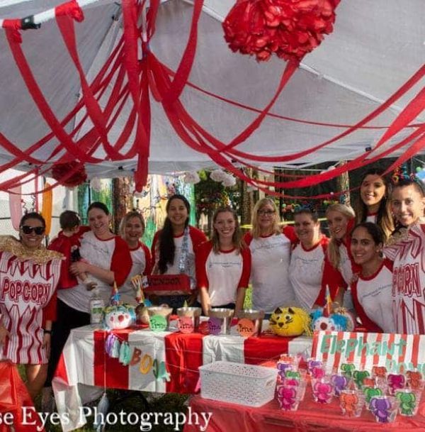 A group of people posing for a photo with one wearing a shirt that says popcorn