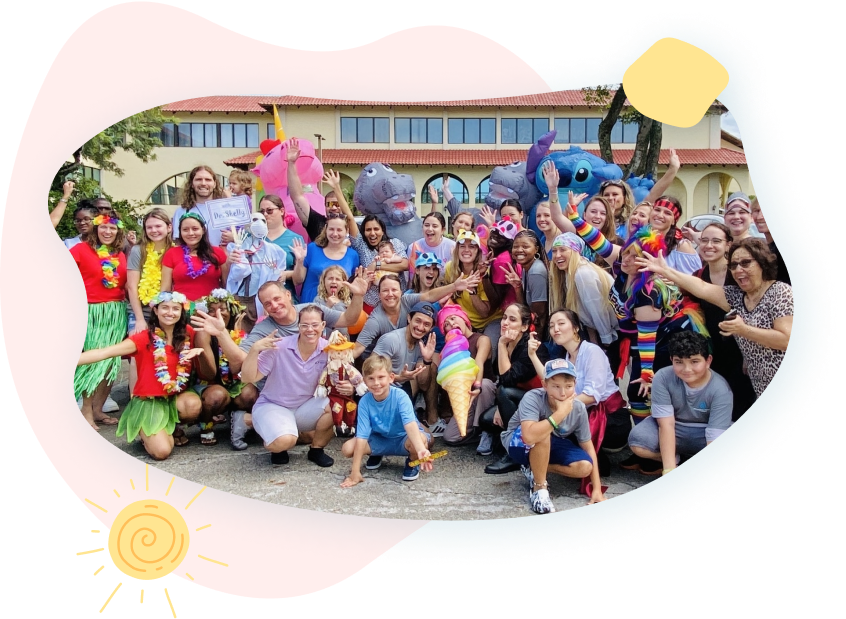 A large group of people are posing for a picture in front of a building.