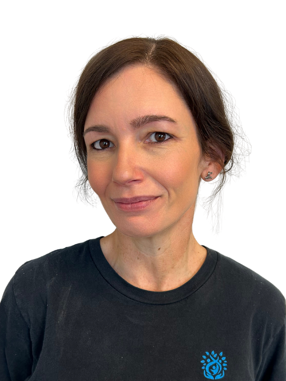 A woman is wearing a black t-shirt and smiling for the camera.