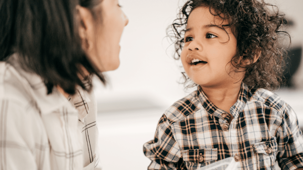 A woman and a little boy are talking to each other.
