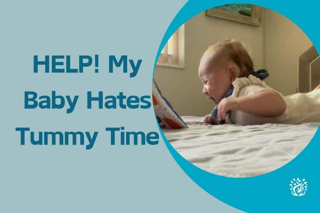 A baby is laying on a bed looking at a tablet.