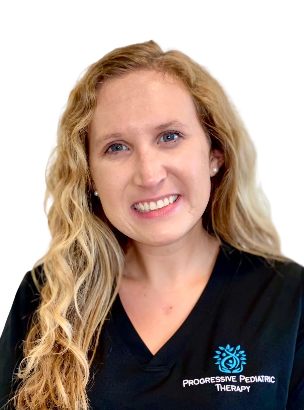 A woman wearing a black scrub top is smiling for the camera.