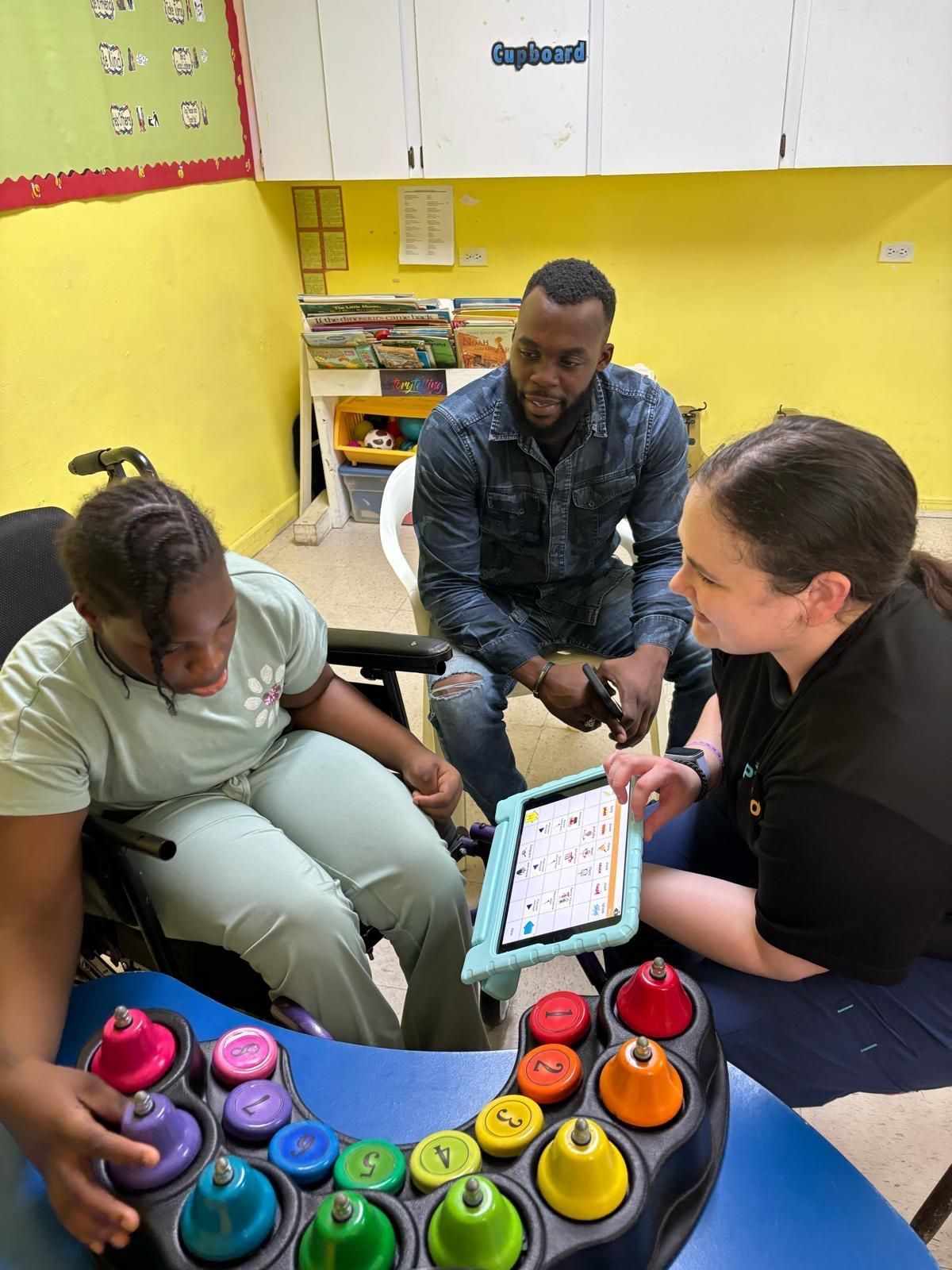 A group of people are sitting around a table playing a game.