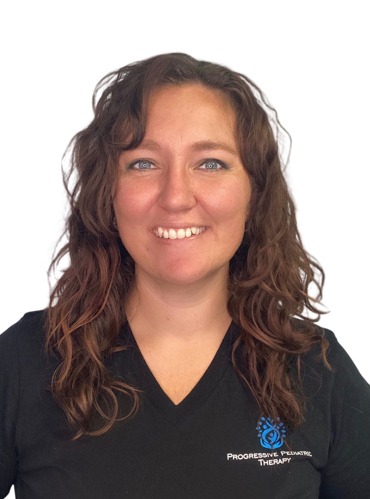 A woman wearing a black scrub top is smiling for the camera.