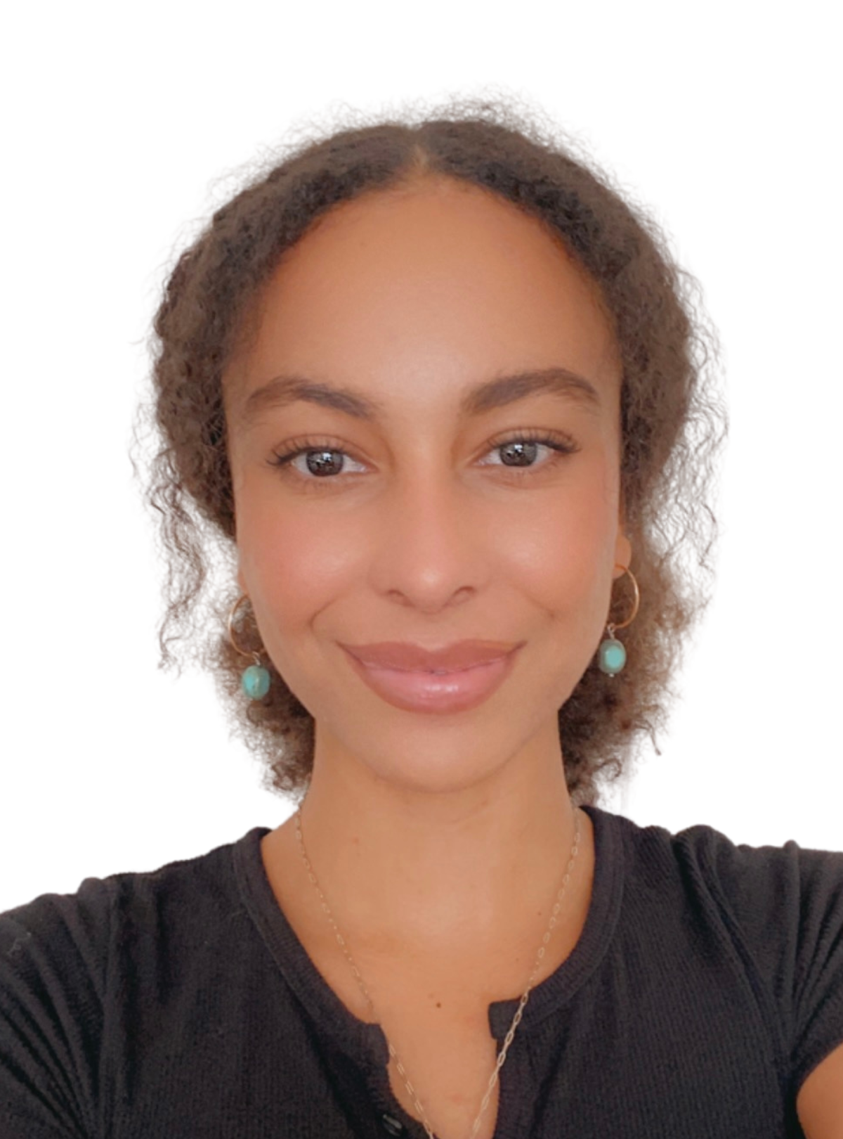 A woman wearing a black shirt and earrings is smiling for the camera.