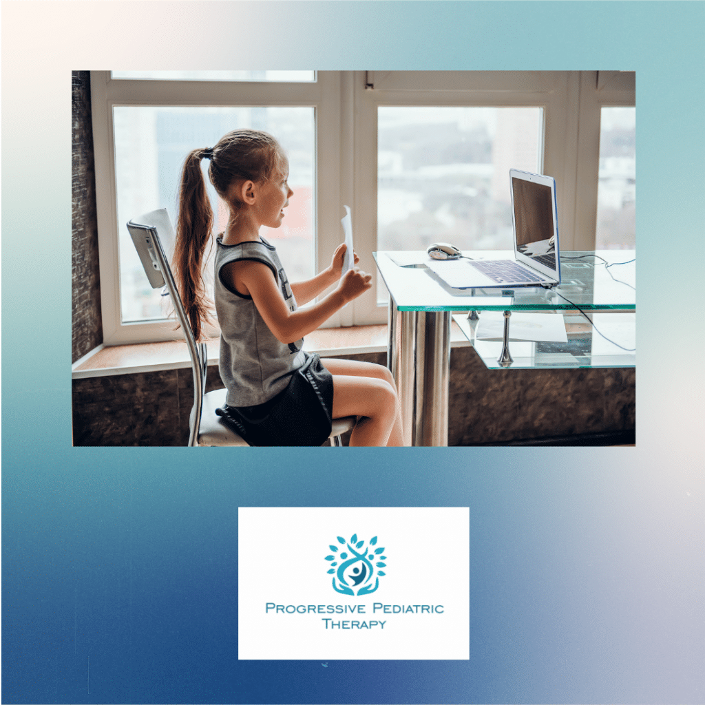 A little girl is sitting at a desk with a laptop and a tablet.