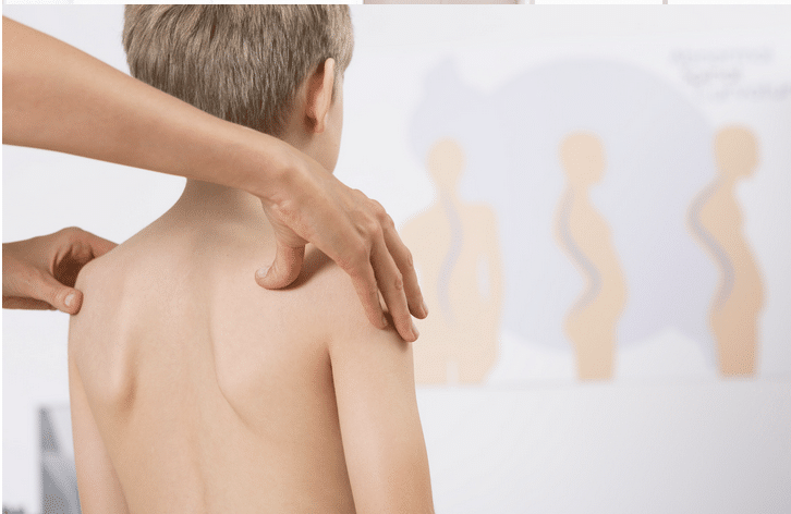 A person is giving a child a massage on his back.