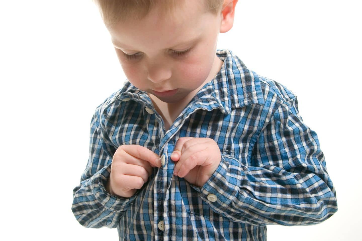 A young boy is wearing a blue and black plaid shirt