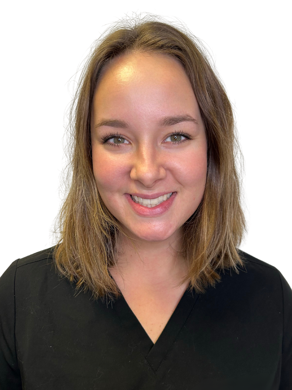 A woman in a black scrub top is smiling for the camera.