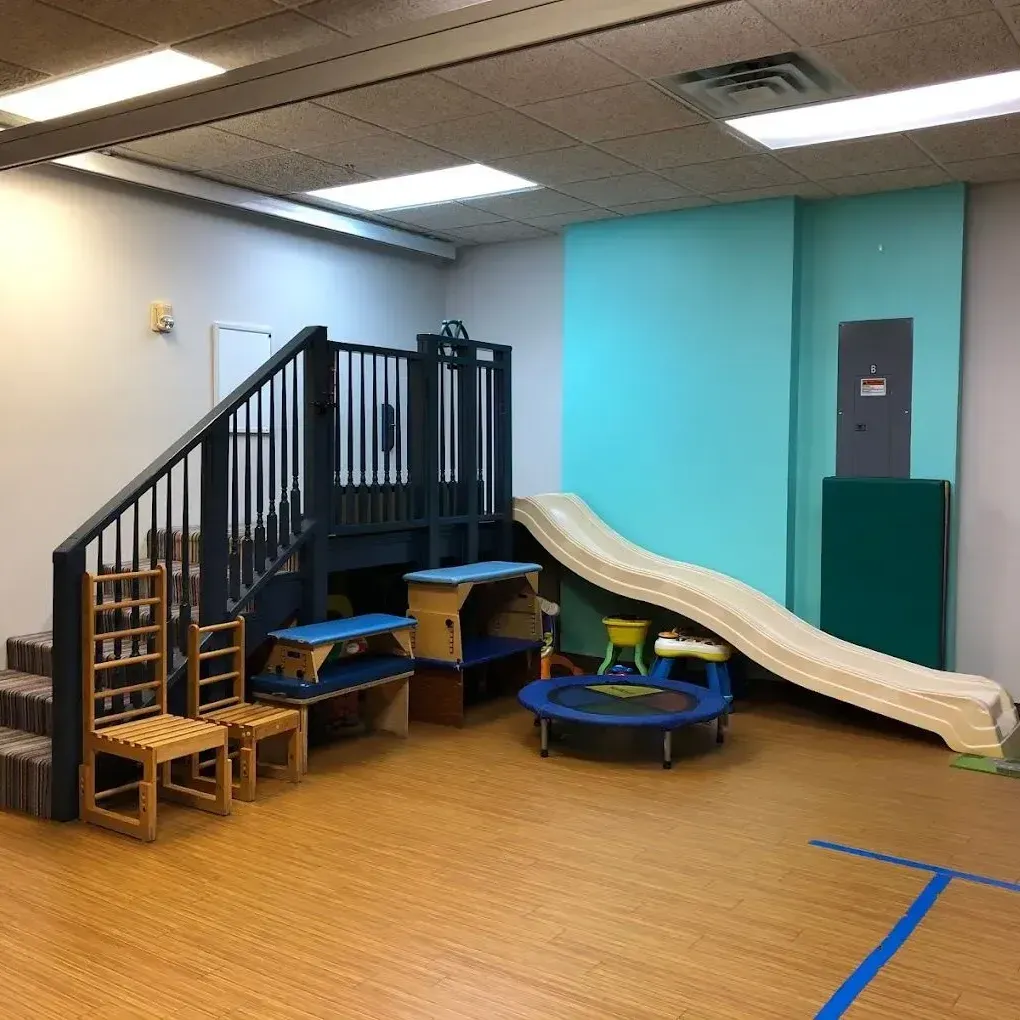 A room with a slide and a trampoline in it