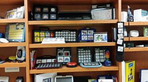 A shelf filled with a variety of electronic devices