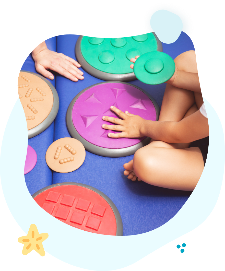 A child is playing with a bunch of toys on the floor