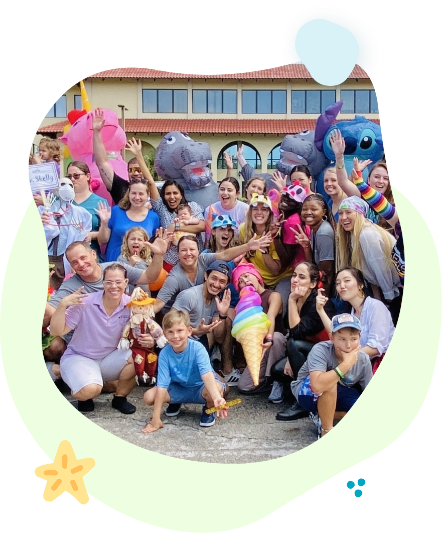 A large group of people are posing for a picture in front of a building.