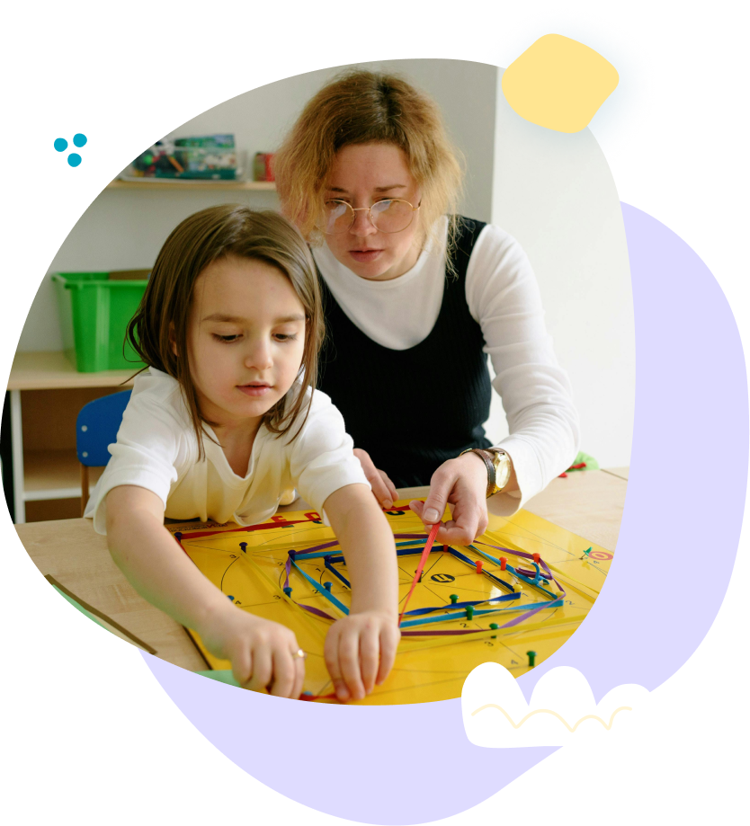 A woman and a little girl are playing with blocks on a table.