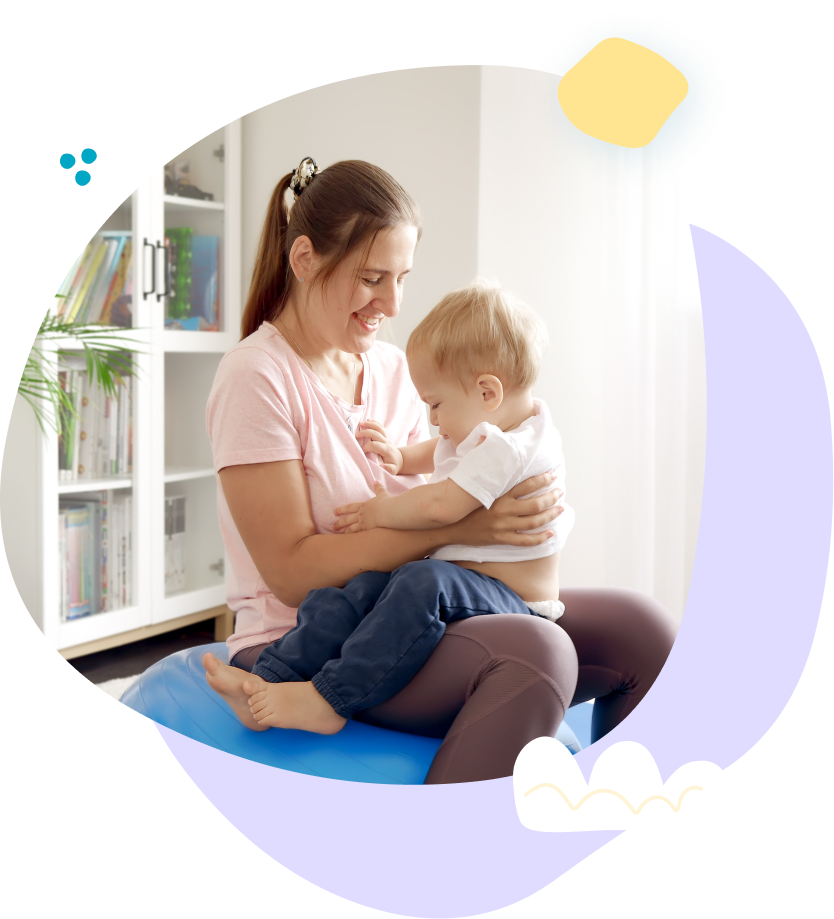 A woman is holding a baby on her lap.