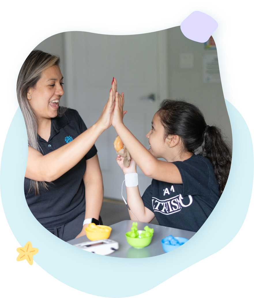 A woman and a little girl are giving each other a high five.