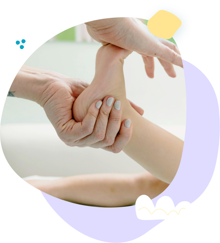 A woman is holding a little girl 's hand in a hospital room.
