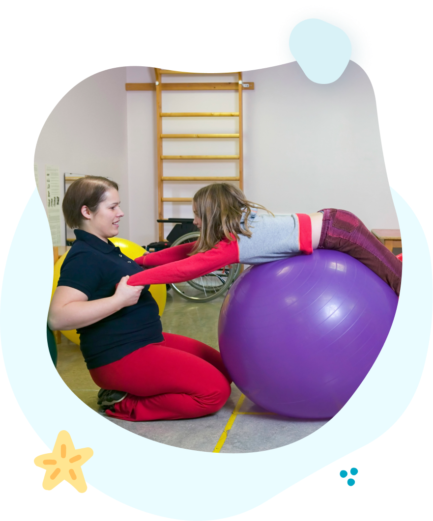 A woman and a child are playing with a purple exercise ball.