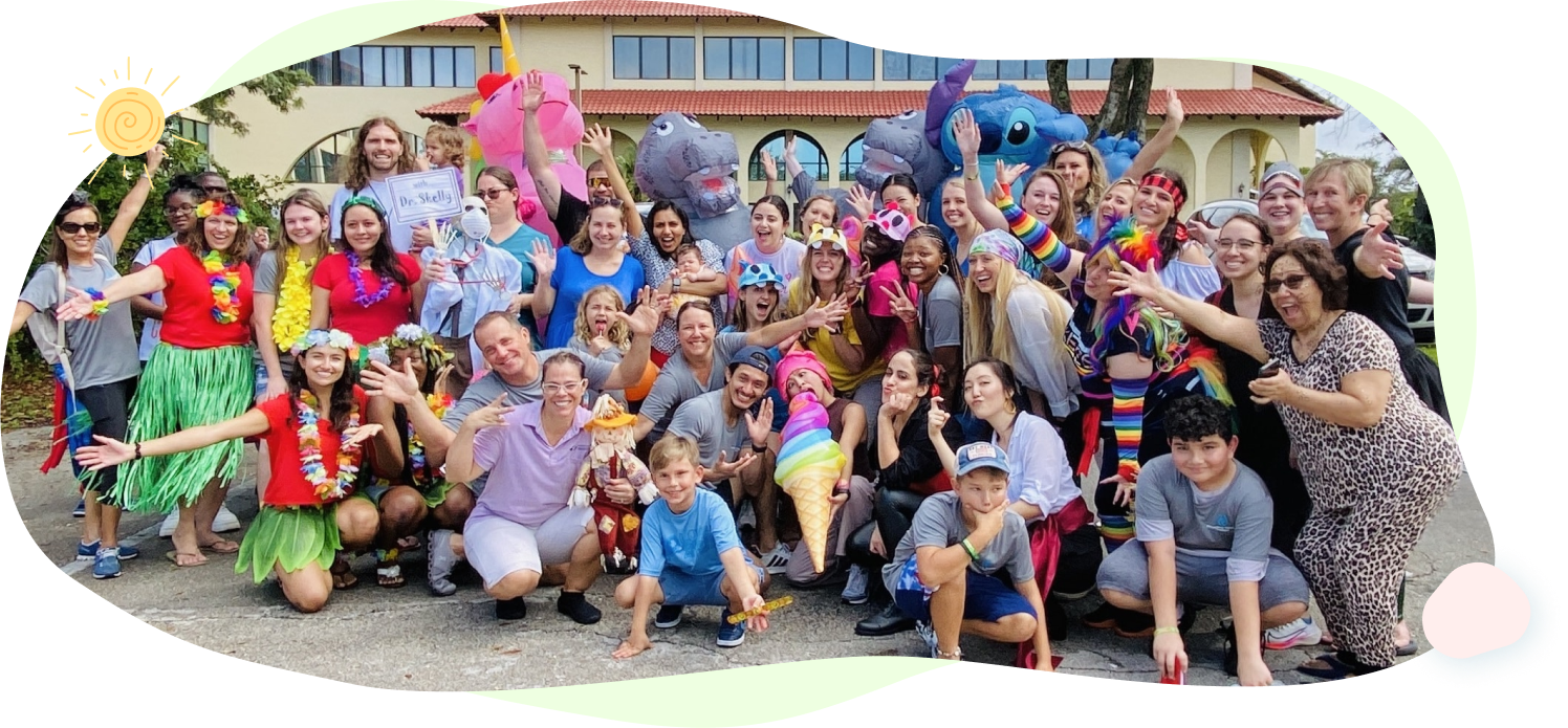 A large group of people are posing for a picture in front of a building.