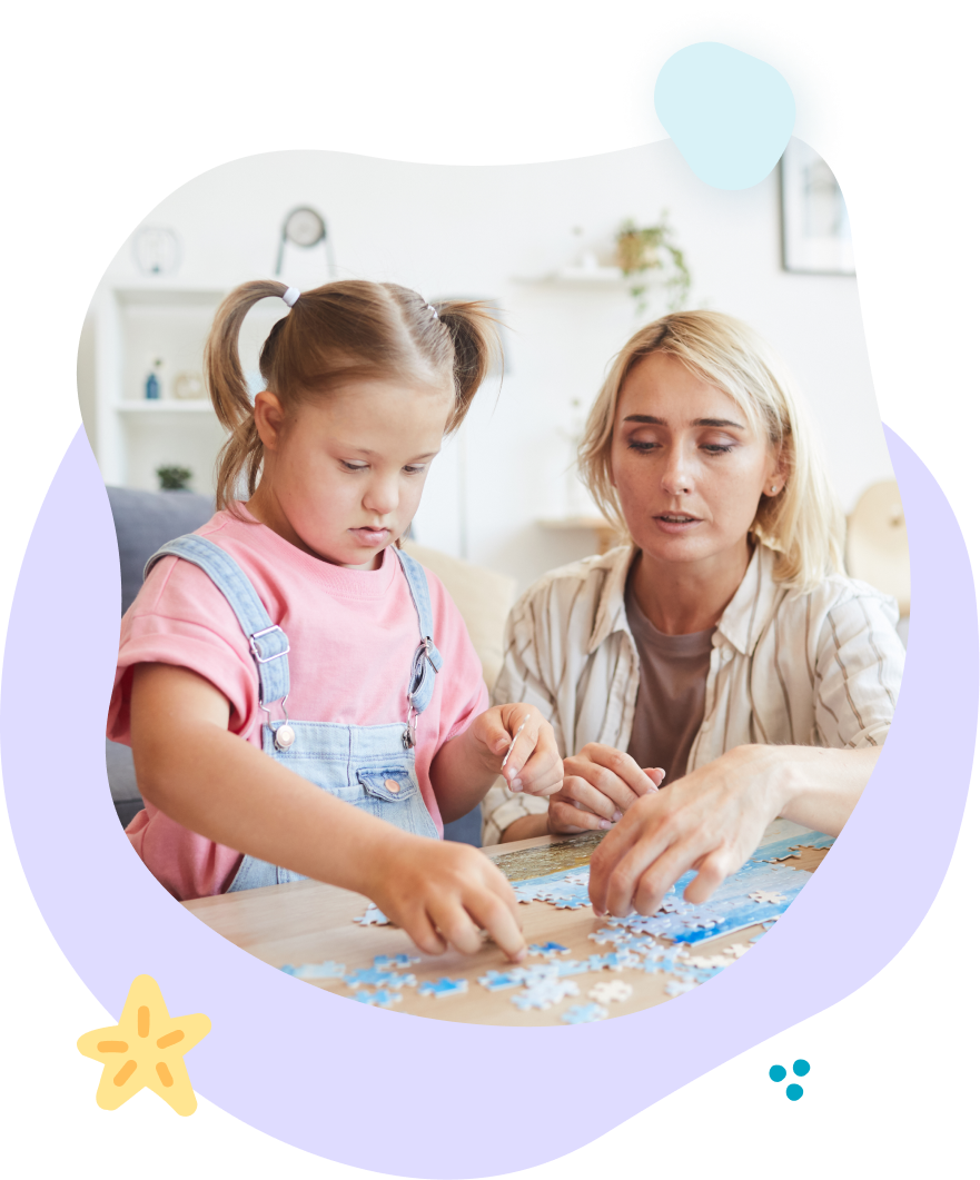 A woman and a little girl are playing a puzzle together.