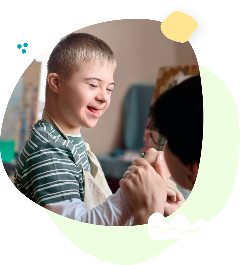 A man and a boy with down syndrome are holding hands.