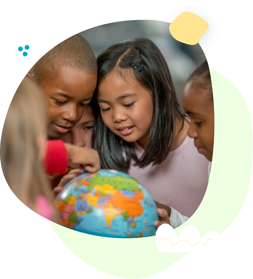 A woman is kneeling down next to a toddler who is standing on a platform.