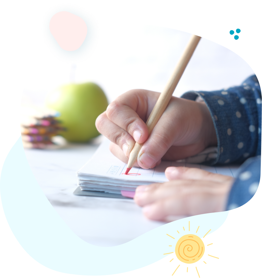 A child is writing in a notebook with a pencil.