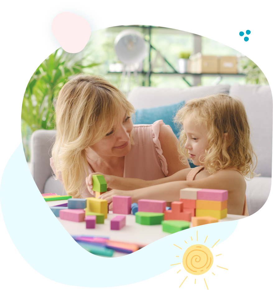 A woman and a little girl are playing with blocks on a table.