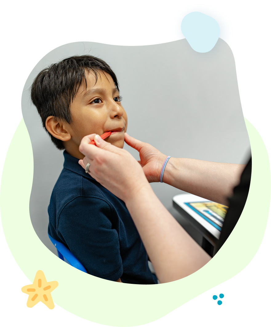 A woman is playing with a child who is playing with blocks.