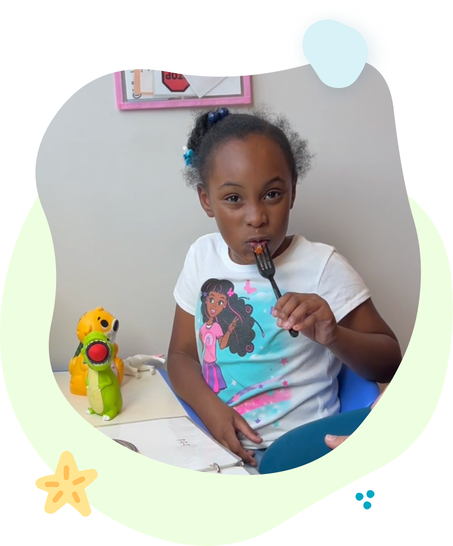 A woman is playing with a child who is playing with blocks.
