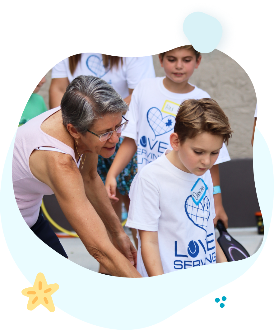 A woman is helping a young boy who is wearing a love spring shirt.