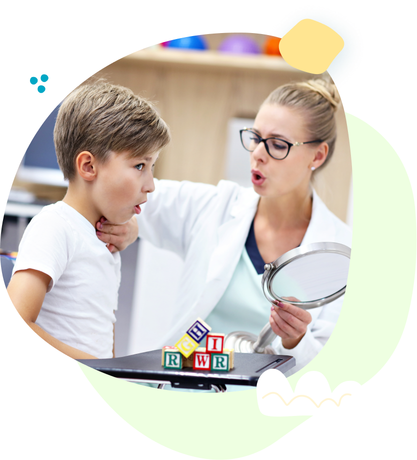 A woman is holding a mirror and talking to a young boy.