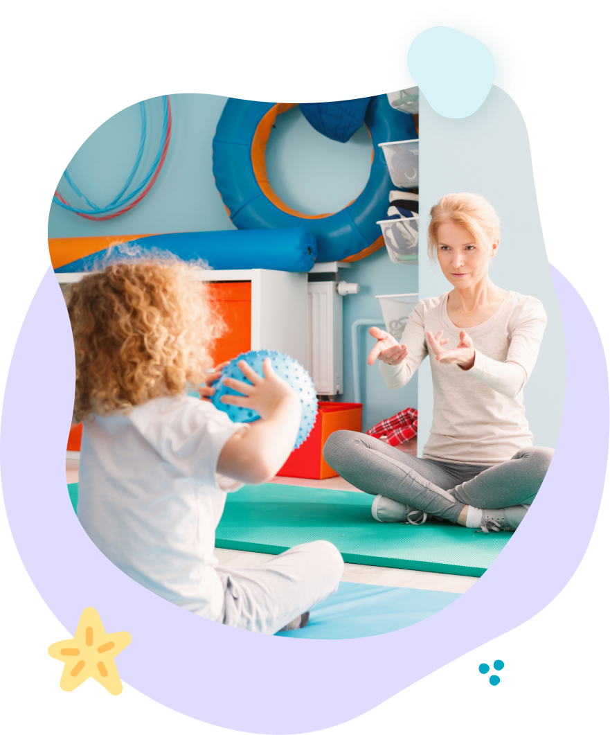 A woman is teaching a child how to play with a ball.