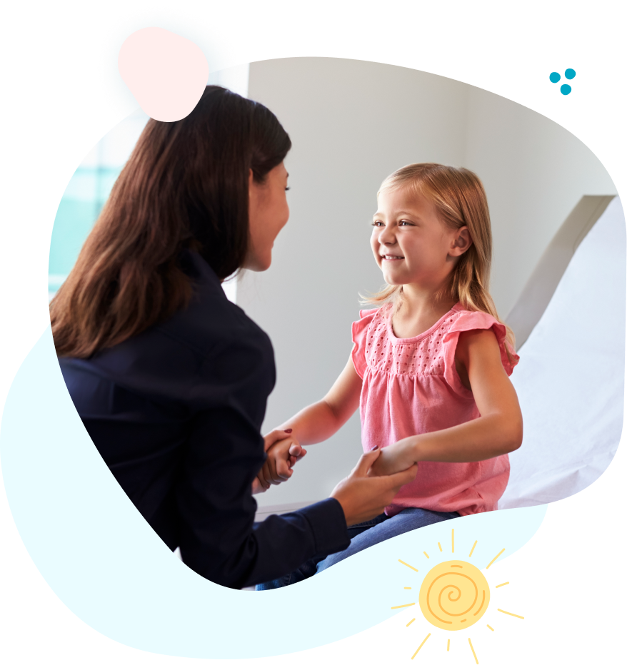 A woman is holding a little girl 's hand in a hospital room.