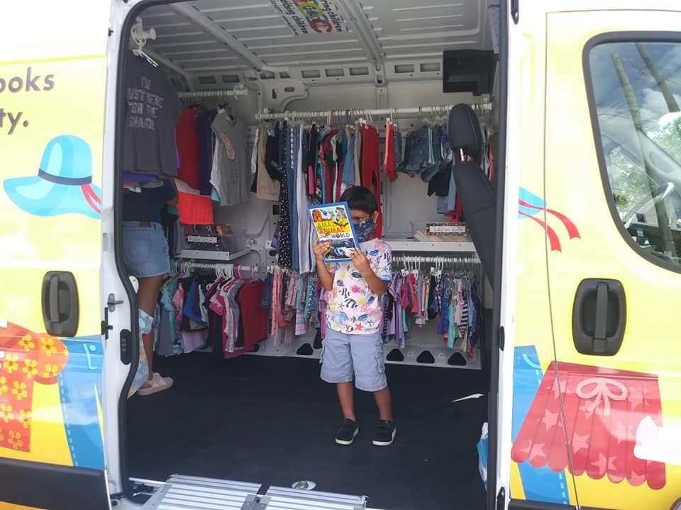 Child reading in Mobile Clothing Unit