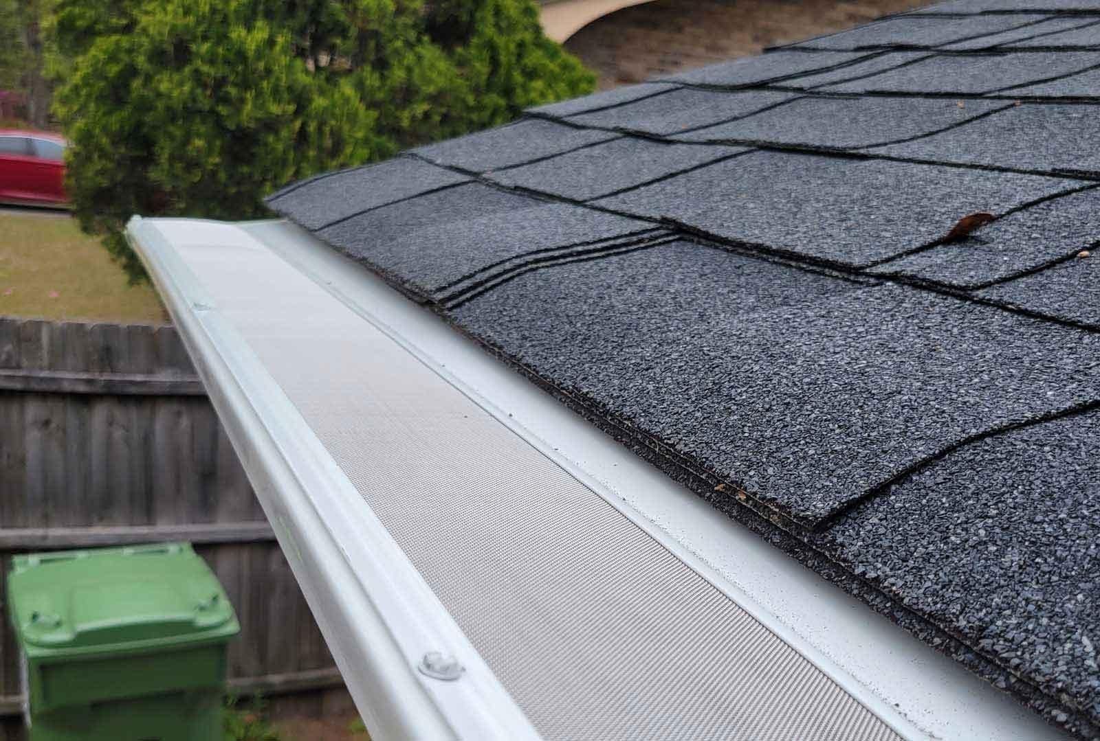 A close up of a gutter on top of a roof.