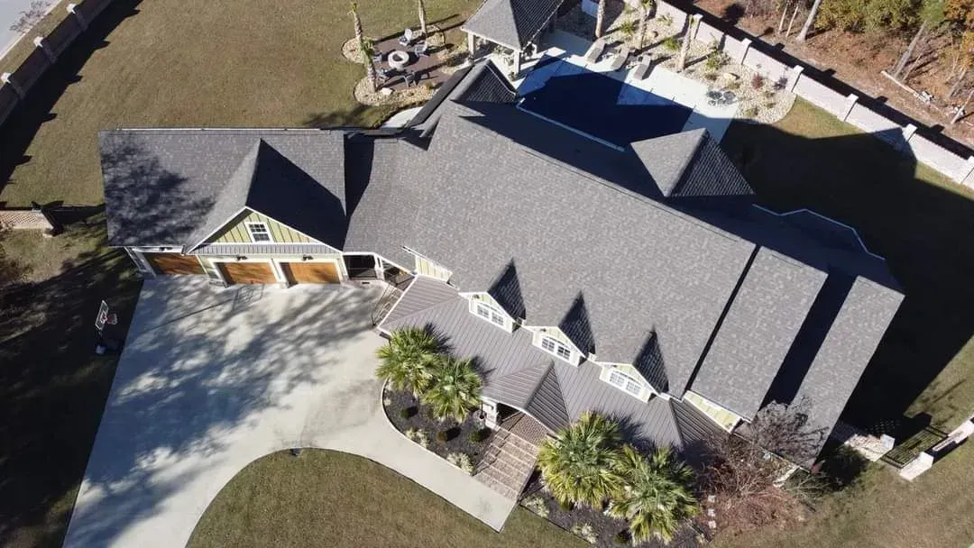 An aerial view of a large house with a large driveway.