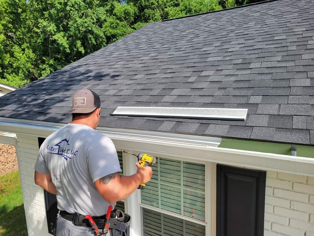 A man is working on the roof of a house.