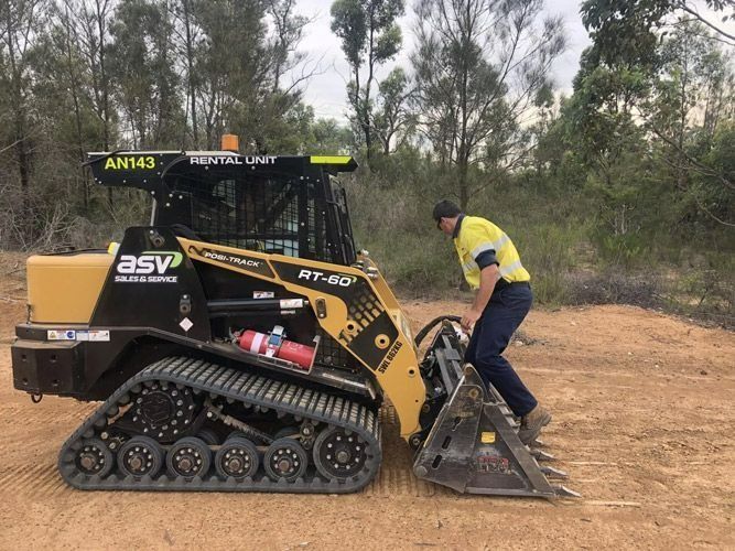 Man Fixing Mini Excavator — Verification of Competency Port Macquarie