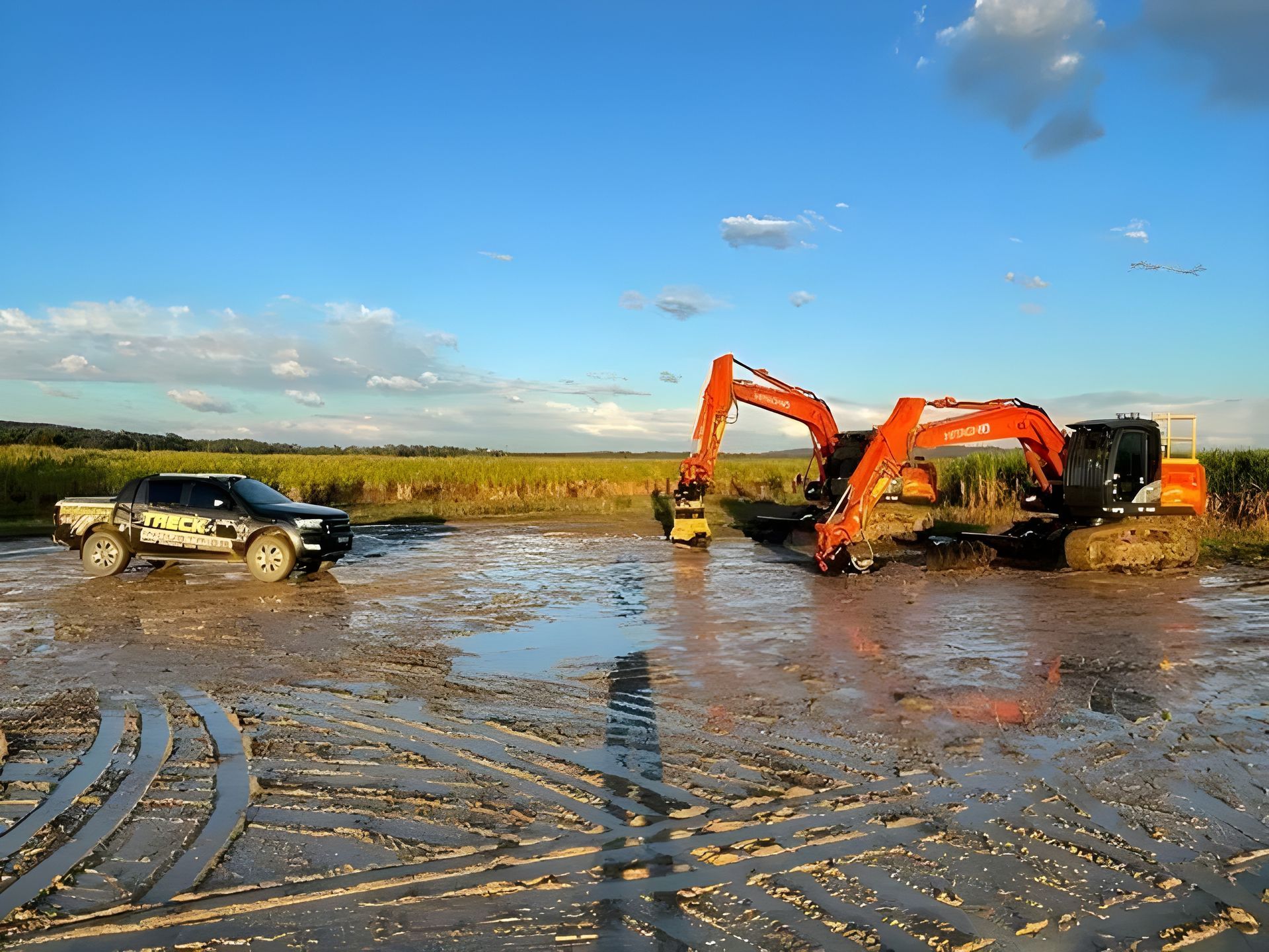 Ute and Two Excavators in the Mud — Plant Operator Courses Maitland