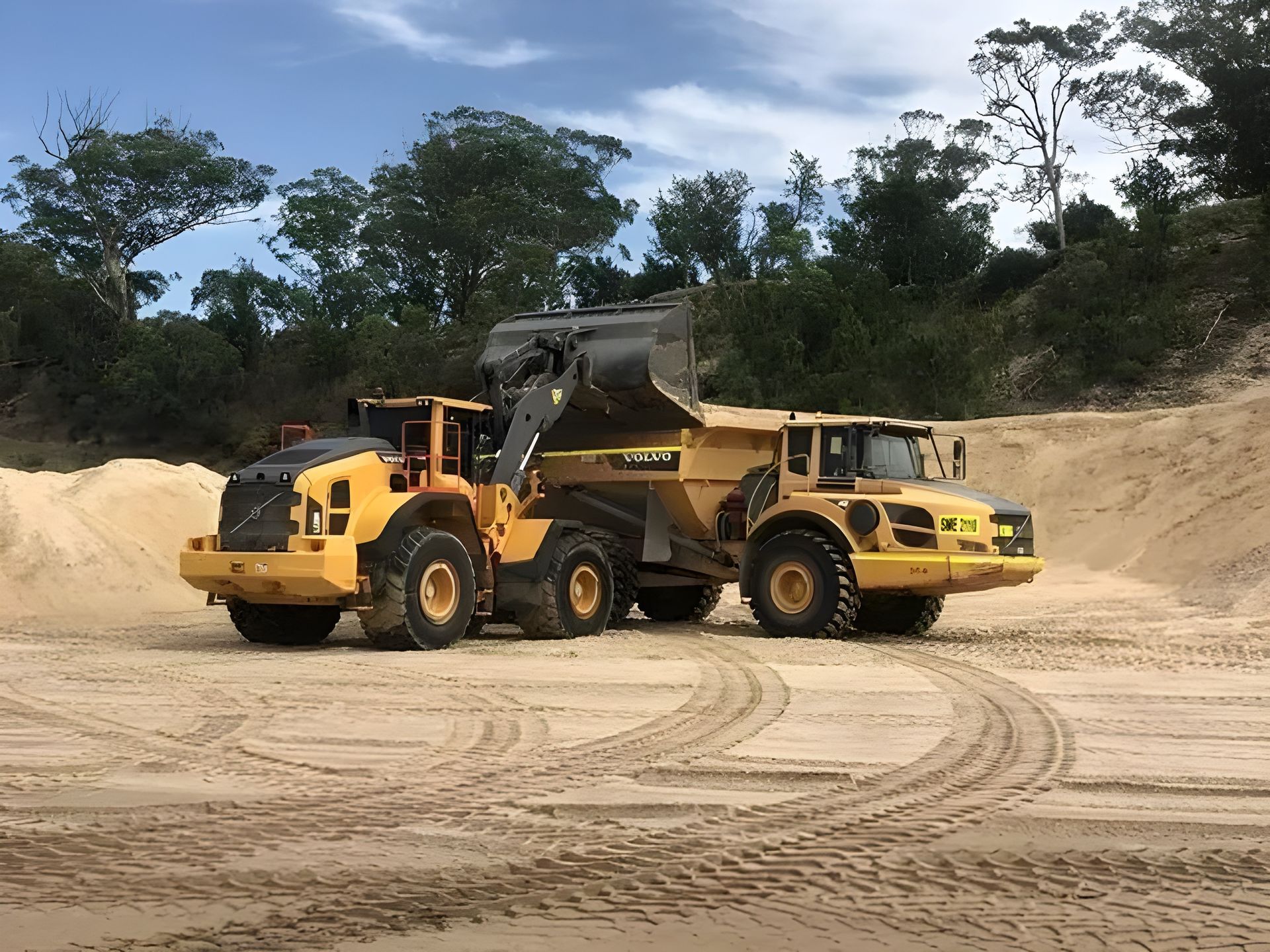 Dump Truck Being Loaded with Dirt by Backhoe Loader — Plant Operator Courses Port Macquarie