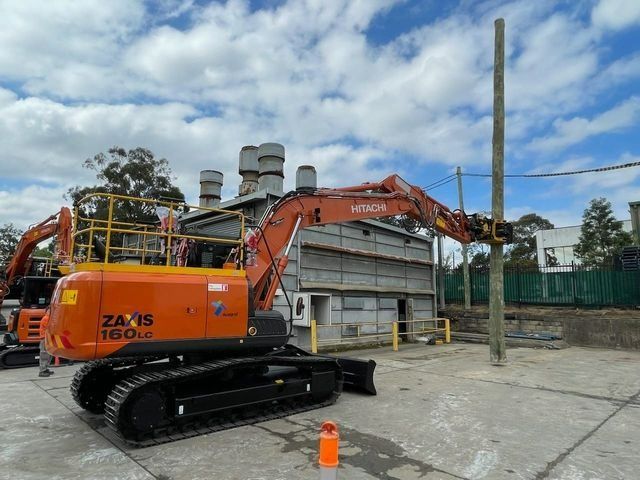 Excavator with Claw Working with Lumber — Statement of Attainment Mid North Coast