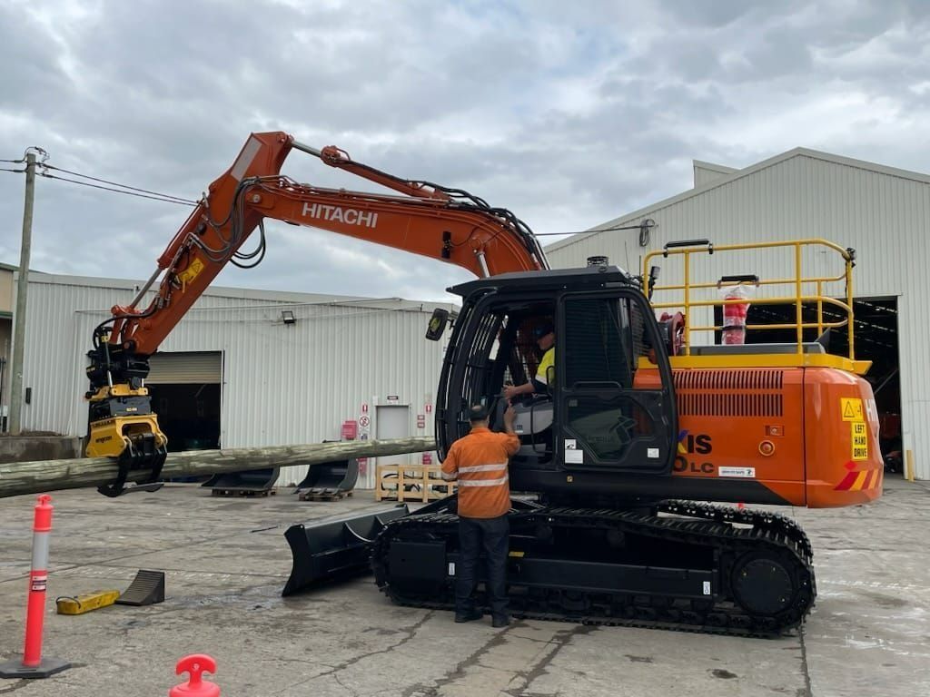 Man Talking to Excavator Operator — Verification of Competency Central Coast