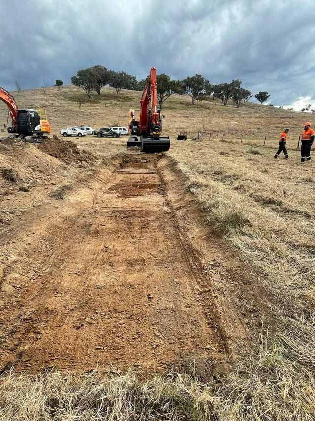 A digger working in a field, levelling the ground — Statement of Attainment Hunter Region