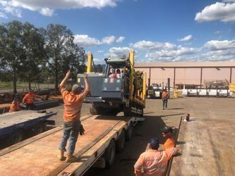 Worker Guiding Forklift Driver Onto Truck Bed — Plant & Machinery Training in the Hunter Region