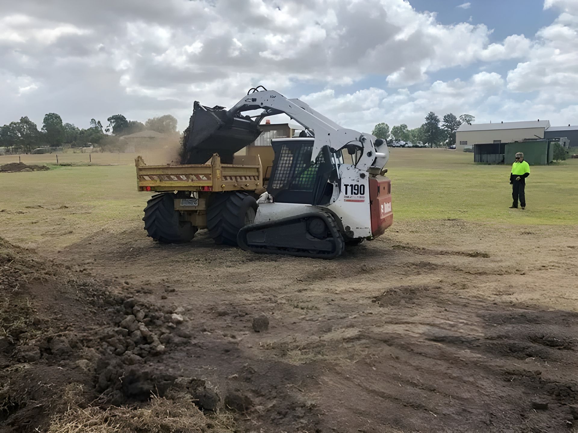 Mini Excavator Loading Sand Into Truck Tray — Statement of Attainment Mid North Coast