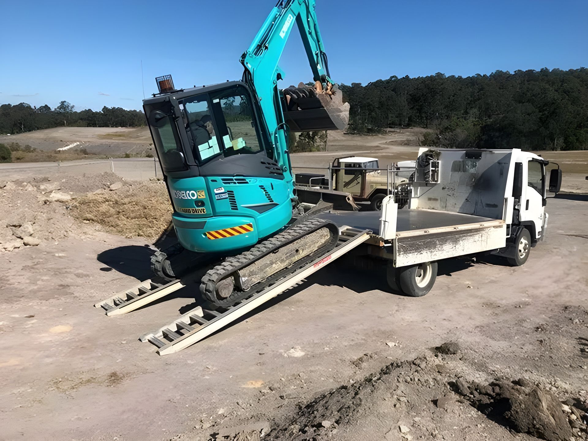 Flatbed Truck with Mini Excavator — Plant Operator Courses Newcastle