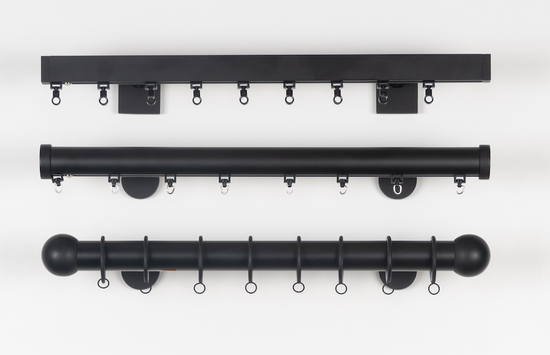 A living room with a couch , table , and curtains.