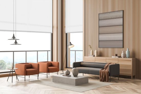 A living room with a couch , chairs , a coffee table and a balcony.